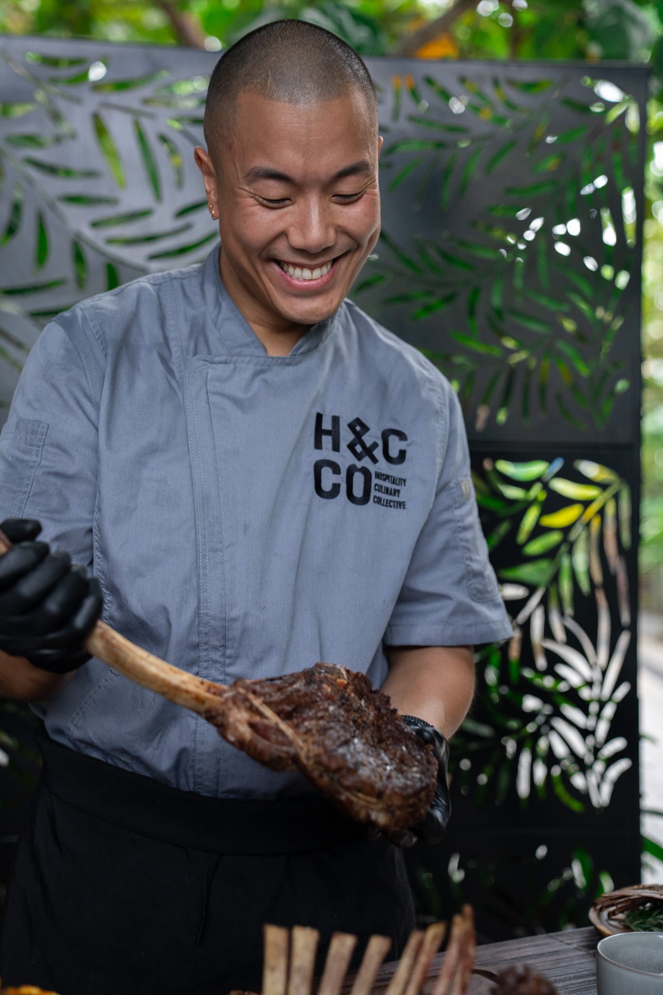 Chef cooking tomahawk steak outdoor culinary photography Miami